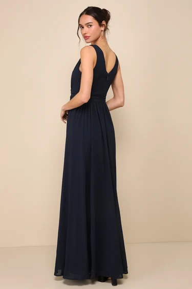 Click here to get your hands on this amazing piece. Lulus's Thoughts of Hue Navy Blue Surplice Maxi Dress will have you fantasising about romantic evenings under the stars! A sleeveless, surplice bodice with a V-back is draped over a banded waistline in lightweight woven Georgette fabric. With a sensual side split, the cascading skirt cascades to a maxi hem. With a clasp in the back, there is a hidden zipper.
